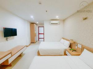 Postel nebo postele na pokoji v ubytování Bella Hotel Bai Sau Vung Tau