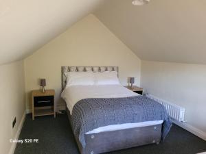 a bedroom with a large bed in a attic at Beechwood House ,Apartment C15YA44 in Slane