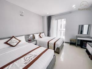 Postel nebo postele na pokoji v ubytování Bella Hotel Bai Sau Vung Tau