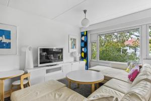 a living room with a couch and a table at Happy Home Lauttasaari in Helsinki