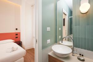 a bathroom with a sink and a mirror at DEM Hotel in Rome +42 photos