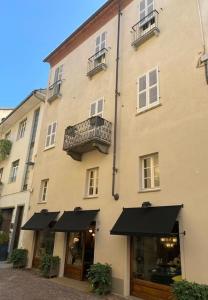 een groot gebouw met zwarte parasols ervoor bij Suite Vittorio Emanuele in Alba