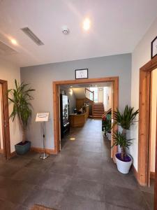 a hallway with potted plants in a building at Afan Lodge in Port Talbot