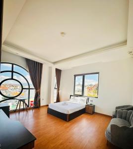 a large bedroom with a bed and a couch at TTR Midtown View Hotel in Da Lat