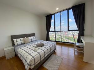 a bedroom with a bed and a large window at KL Gateway Penthouse w Karaoke by Cobnb in Kuala Lumpur