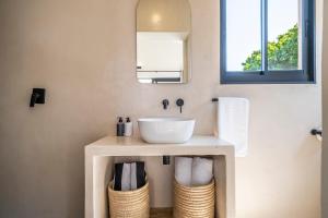 a bathroom with a white sink and a mirror at SALT in Jeffreys Bay