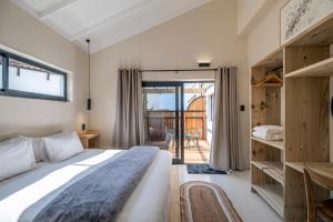 1 dormitorio con 1 cama grande y balcón en SALT, en Jeffreys Bay
