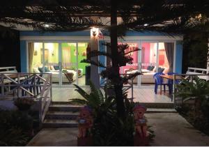 a house with a porch with a table and chairs at Tonkaew Khaokao Resort in Campson