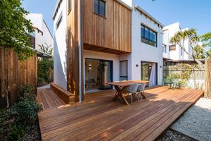 a wooden deck with a table and chairs on a house at SALT in Jeffreys Bay