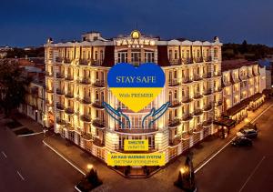 a large building with a sign that reads stay safe with promise at Premier Hotel Palazzo in Poltava