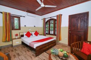 a bedroom with a bed and a table in a room at Sunny's Garden Hotel in Ambalangoda