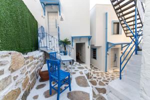 a small patio with blue chairs and stairs at Cozy Seaside Paradise 3 min to Beaches in Bodrum in Bodrum City