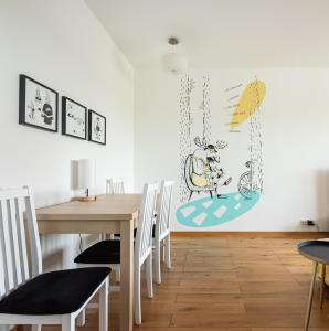 a dining room with a table and chairs at Bemowo Kocjana 2-Bedroom Apartment in Warsaw
