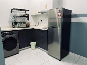 een keuken met een koelkast en een wasmachine bij Arte Cheras 022 with 6 pax in Kuala Lumpur