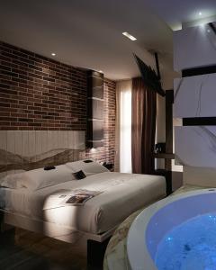 a bedroom with a large bed and a bath tub at Mamaco I Teatro Rooms in Foggia