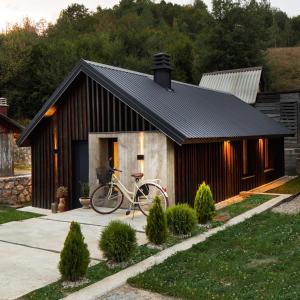 a bike parked in front of a house at Wood cabin Kolasin in Kolašin