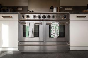 a large stainless steel stove in a kitchen at Chalet Crêt Beni in La Chapelle-dʼAbondance
