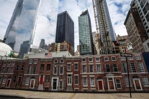 a red brick building in a city with tall buildings at FiDi studio w gym doorman nr Freedom Tower NYC-1088 in New York