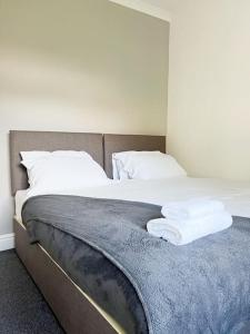 a bed with two towels on top of it at Millfield House by Blue Skies Stays in Middlesbrough