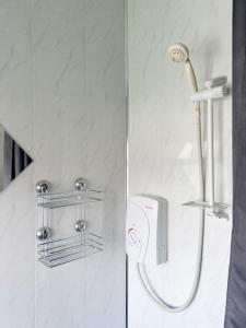 two pictures of a shower in a bathroom at Millfield House by Blue Skies Stays in Middlesbrough