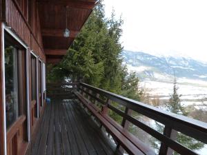 a balcony of a house with a view of the mountains at Chalet Cèdre Rouge in Enchastrayes