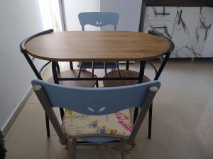 a wooden table and two chairs and a table and chairs at Helen's downtown apartment in Ioannina