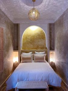 a bedroom with a large bed with a window at Riad Citrus in Marrakech