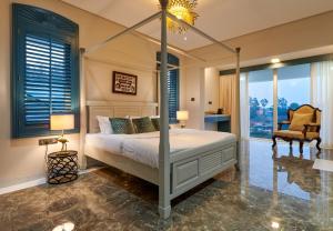una camera con letto a baldacchino e sedia di Clouds Nest By Aanvis Inn a Ooty