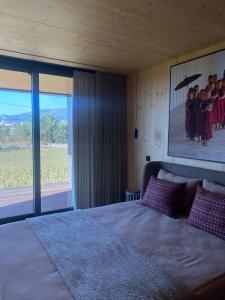 a bedroom with a bed with a picture of children at Quinta das Areias - Solar da Pena in Braga