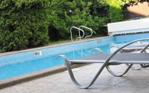 a table and chairs next to a swimming pool at Hotel Baroko in Prague