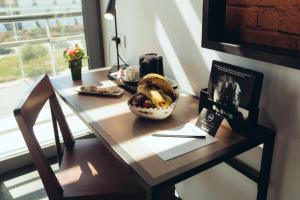 a table with a bowl of bananas and a plate of bread at ONOMO Airport Casablanca in Casablanca