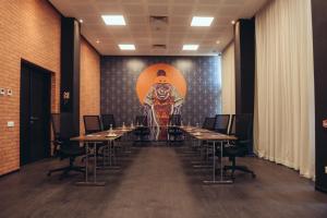 a room with tables and a large painting on the wall at ONOMO Airport Casablanca in Casablanca