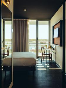 a hotel room with a bed and a table with a view at ONOMO Airport Casablanca in Casablanca +37 photos