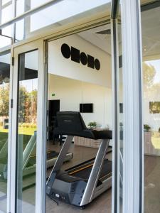 a gym with a treadmill in front of a window at ONOMO Airport Casablanca in Casablanca