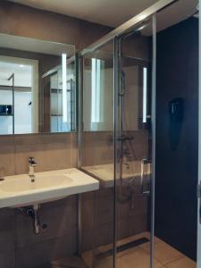 a bathroom with a sink and a shower at ONOMO Airport Casablanca in Casablanca