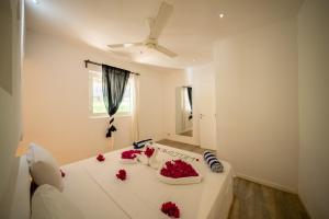 a room with a white table with roses on it at Villa Jiwe with Pool ZanzibarHouses in Kumba Urembo
