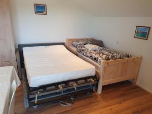 a bed sitting in a room next to a wall at FeWo Rotter Blick in Rott am Inn