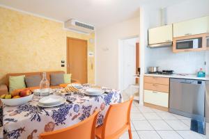 a kitchen and dining room with a table and chairs at Residence Millennium in Rimini