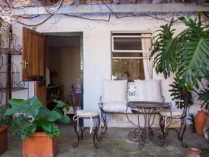 a patio with a couch and a table and chairs at EpiStay in Tulbagh