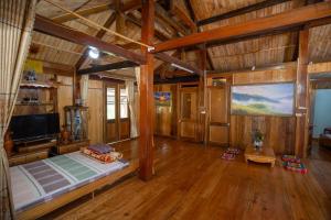 um quarto grande com uma cama e uma televisão em Mu Cang Homestay em Lao San Chay