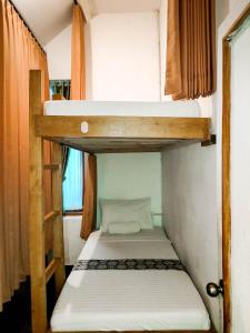two bunk beds in a small room at Ijen Backpacker in Banyuwangi