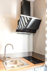 a kitchen with a hood over a sink at Oreli Suite in Heraklio