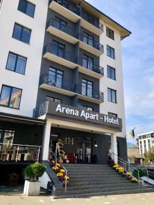 an apartment building with stairs in front of it at Arena Apart - Hotel in Polyana
