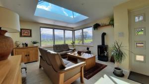 a living room with a couch and a stove at The Lodge Brecon B&B in Brecon