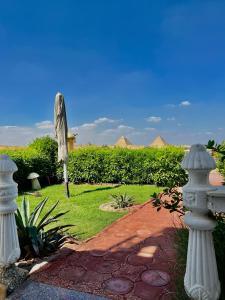 a garden with a statue and a brick path at Horus Mini Resort in Cairo