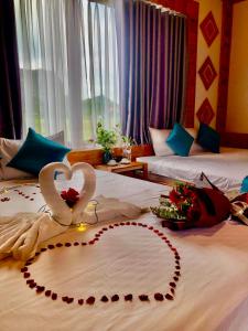 a hotel room with two beds with hearts on them at Rosa Garden in Ninh Binh