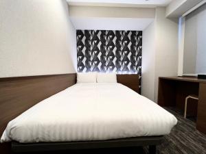 Postel nebo postele na pokoji v ubytování KIN HOTEL