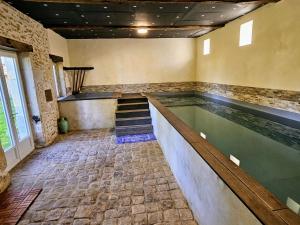 a swimming pool in a building with a swimming pool at Château Arche d'Aure in Vicq-dʼAuribat