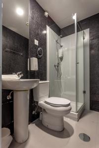 a bathroom with a toilet and a sink and a shower at Guest House Porto Clerigus in Porto +37 photos
