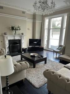 a living room with a couch and a table at Number Nine Torquay in Torquay